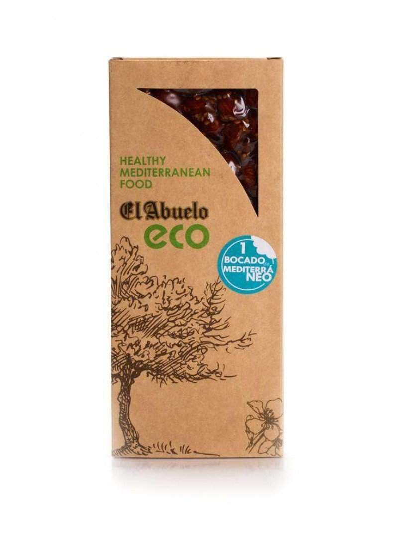 Una caja de cartón etiquetada "Turrón Crocant con Sésamo Ecológico El Abuelo 200 grs." de Jijona S.A., Partida de Alequa s/n, Jijona, Alicante, tiene una ventana transparente que muestra el turrón y lleva una ilustración de un árbol y "Comida Mediterránea Saludable.